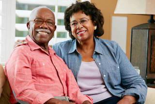 older couple sitting together on couch I dentist in moline il