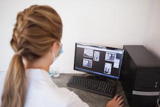 dentist peering at digital x-ray I digital dentistry in moline il