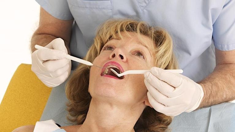 Woman receiving dental exam at Moline IL dentist office